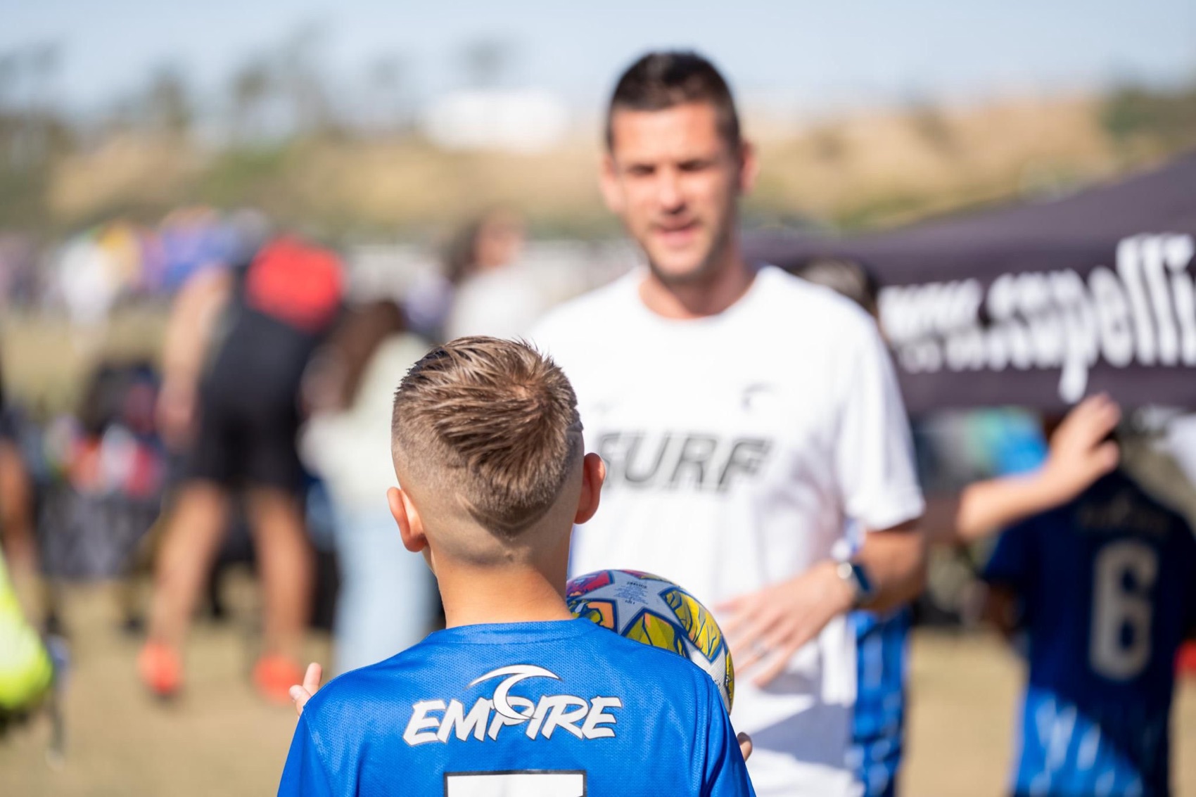 Coach Lee Underwood working one-on-one with a youth soccer player